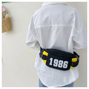 Detail view of the yellow and black kids' waist bag featuring white 1986 text