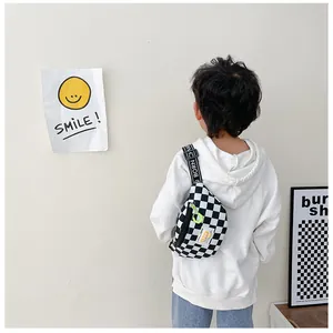 Close-up of kids checkerboard chest bag with adjustable letter strap and neon zipper detail
