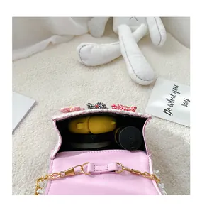Internal detail of pink tweed mini bag with chain strap and flower decorations