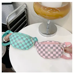 Detail of quilted checkerboard waist bags in mint green and pink with FASHION label