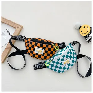 Detail of checkerboard kids waist bag showing adjustable straps and neon green zippers
