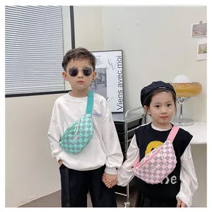 Close-up of kids checkered waist bags in mint green and pink with fashion labels