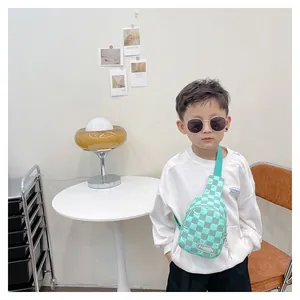 Detail showing mint green checkerboard kids chest bag with Fashion label strap