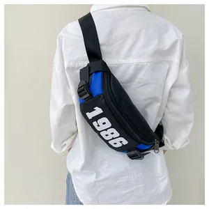 Rear view of model wearing a retro 1986 blue and black crossbody sling bag for kids