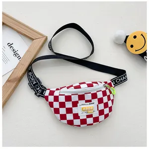 Detail of red checkerboard kids chest bag with Born Champ lettered strap and neon puller