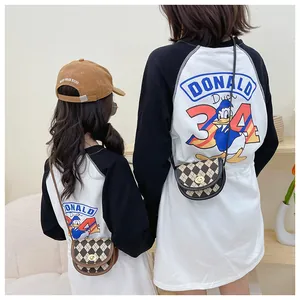 Detail of a brown quilted saddle bag paired with black and white Donald Duck raglan tops