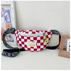 Close-up of red and white checkerboard chest bag with ADDR label and green zipper pull