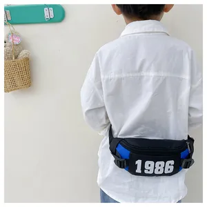 Rear view of a boy wearing a blue and black checkerboard kids fanny pack with 1986 print