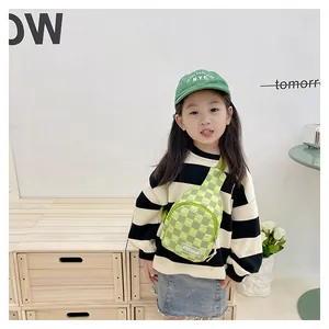 Detail of green checkerboard kids chest bag with adjustable strap and fashion label