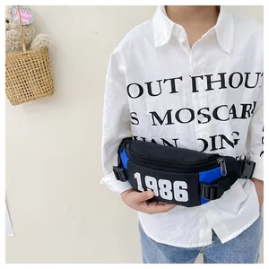 Close-up of children's waist bag with 1986 number print and adjustable black buckle strap