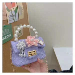 Detail of lavender mini bag with pearl handle and 3D floral accent for girls