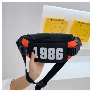 Close-up of black and red kids waist bag with 1986 print and adjustable strap