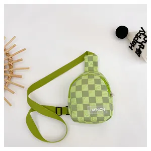 Detail of green checkerboard kids chest bag with adjustable strap and fashion label
