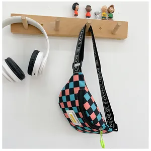 Close-up of a pink and blue checkerboard kids' fanny pack with a branded shoulder strap