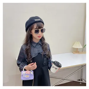 Detail of girls' vintage plaid dress set with beret, sunglasses, and pearl strap purple bag