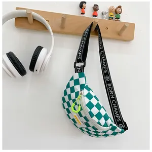 Detail of green checkerboard kids chest bag with adjustable lettered strap and zipper