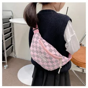 Close-up of pink and grey checkerboard kids chest bag with adjustable strap and fashion label