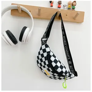 Detail of checkered kids chest bag with logo strap and neon green zipper puller