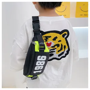 Detail of neon green kids chest bag with 1986 print and adjustable nylon strap buckle