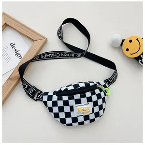 Detail of checkered kids fanny pack with neon green hook and branded straps