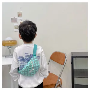 Detail of kids light green checkered chest bag with white zipper and fashion label