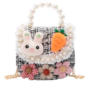 Black and white plaid children's crossbody bag with pearl handle and plush rabbit decor