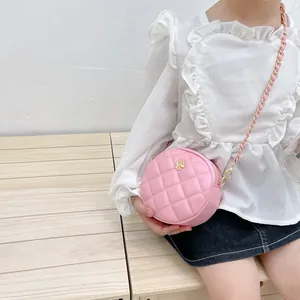 Pink quilted round mini crossbody bag for girls with gold flower accent and chain strap