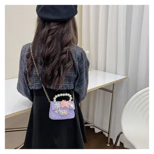 Girl's back view showing mini purple lace handbag with pearl handle and chain strap