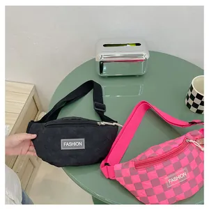 Close-up of quilted black and purple checkerboard waist bags with FASHION label