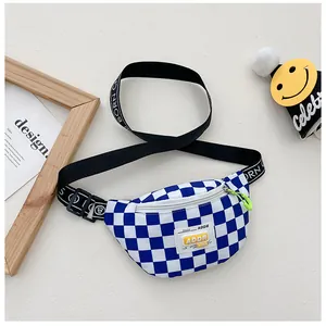 Detail of blue checkerboard waist bag with green puller and lettered strap