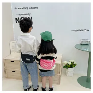 Kids chest bags in solid black and pink checkerboard with adjustable straps