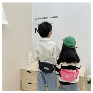 Rear view of child models wearing black and pink checkerboard canvas chest bags