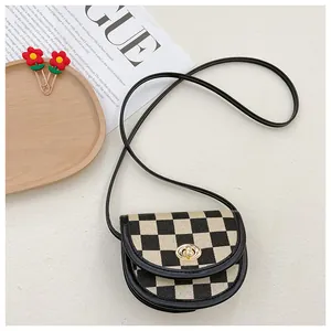 Detail of checkered crossbody bag with golden metal twist lock and thin leather strap
