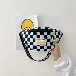 Kids checkerboard chest bag with neon green zipper detail and branded strap for boys