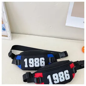Detail of kids chest bags with 1986 print, nylon fabric, and adjustable plastic buckles