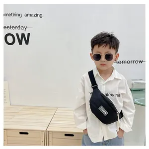 Detailed view of kids black nylon waist bag with Fashion patch and adjustable strap