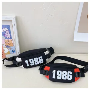 Detail view of two nylon sports waist bags with 1986 number print and buckle straps