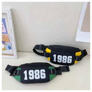 Detail view of nylon kids fanny packs with 1986 print and adjustable buckle straps