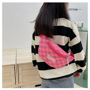Detail view of pink checkerboard kids fanny pack with adjustable strap and fashion label