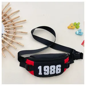 Flat lay of a sporty kids' chest bag with red and black panels and 1986 number print