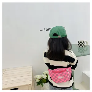 Detail of pink checkerboard kids fanny pack with FASHION patch and white drawstring zip