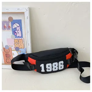Detail of kids chest bag with orange and black contrast, featuring 1986 number print