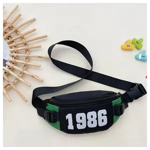 Detail of green and black checkered kids chest bag with 1986 print and buckle