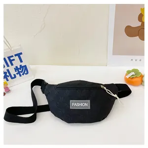 Detail of kids black chest bag featuring unique 3D bubble texture and fashion label