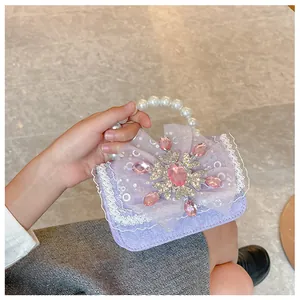 Detail of lavender pearl texture handbag with tulle bow, rhinestone snowflake and lace