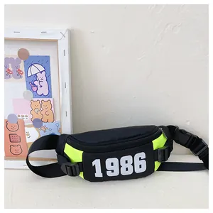 Detail of trendy black waist bag with neon accents and 1986 print for kids
