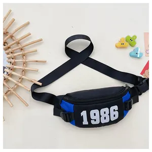 Detail of blue and black nylon kids waist bag featuring retro 1986 number print