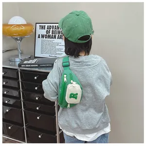 Detail showing green kids canvas chest bag with R letter embroidery and zip closure