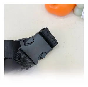 Detail of durable black plastic buckle and high-density nylon webbing for kids chest bag