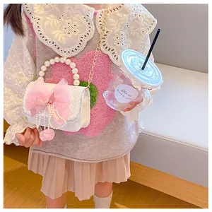 Detail of girls' small handbag with pearl handle, pink tulle bow, and gold chain strap